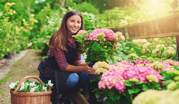 a happy lady enjoying the healthy benefits of gardening